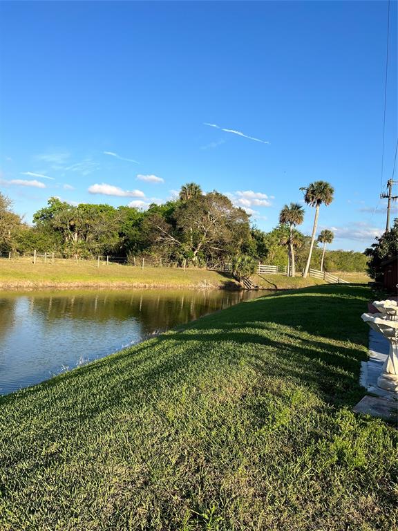6681 Southeast 51st Street Okeechobee, FL 34974 - Photo 2 of 4 a view of a lake with houses in the background