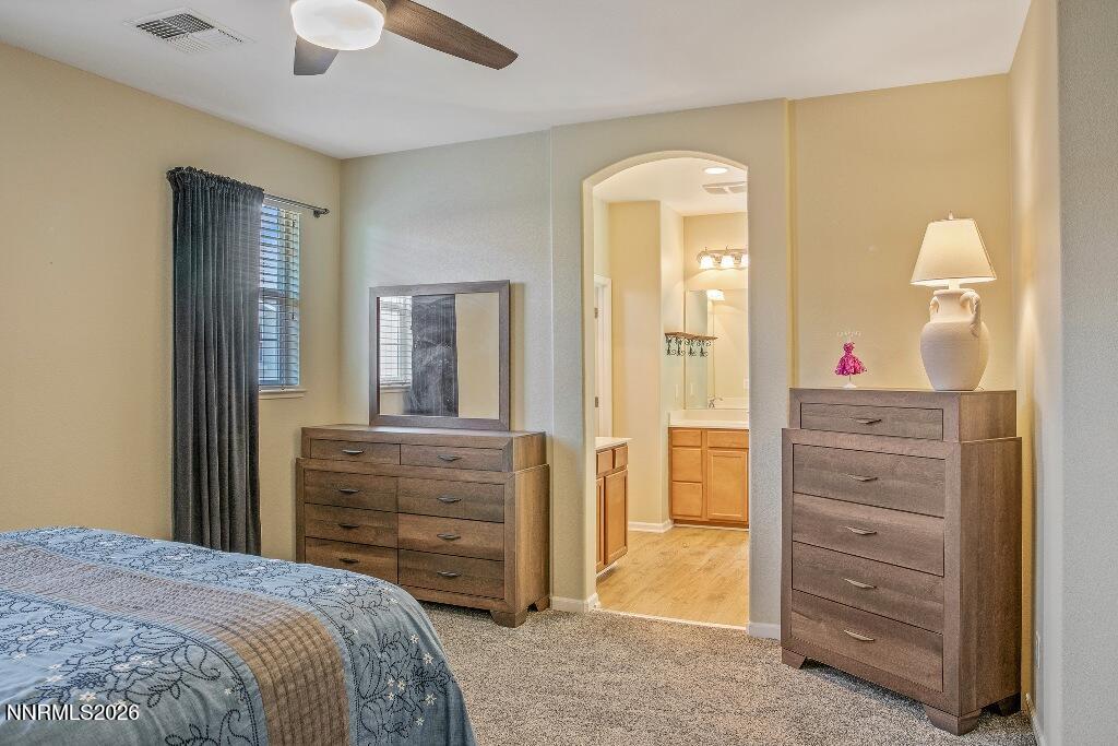 1864 Wind Ranch Road, Unit B Reno, NV 89521 - Photo 18 of 42 a bedroom with a bed and a dresser