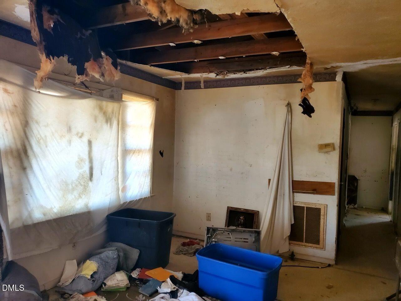 308 Nustreet Road Enfield, NC 27823 - Photo 4 of 6 a blue bed sitting in a room next to a window