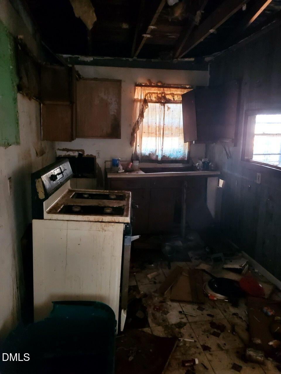 308 Nustreet Road Enfield, NC 27823 - Photo 6 of 6 a room with water heater and wooden cabinets