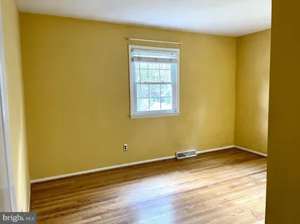 a view of a room with wooden floor and fence