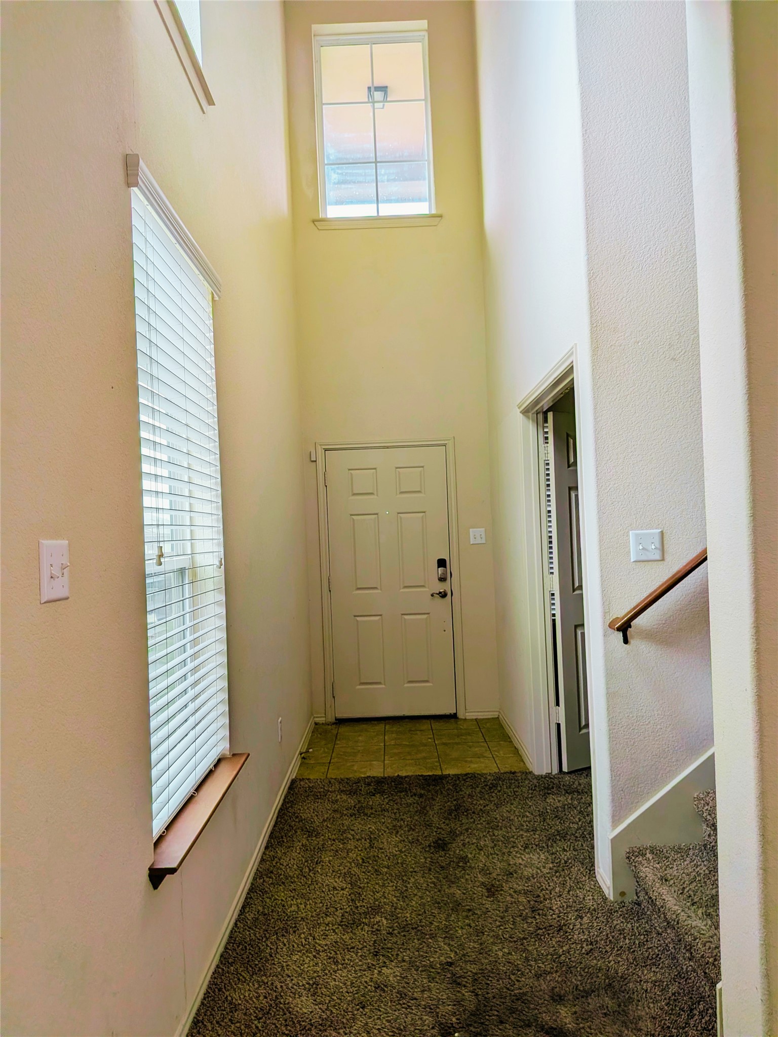 212 Foster Lane Jarrell, TX 76537 - Photo 2 of 26 A tall entryway with a transom window above the front door creates a welcoming atmosphere.