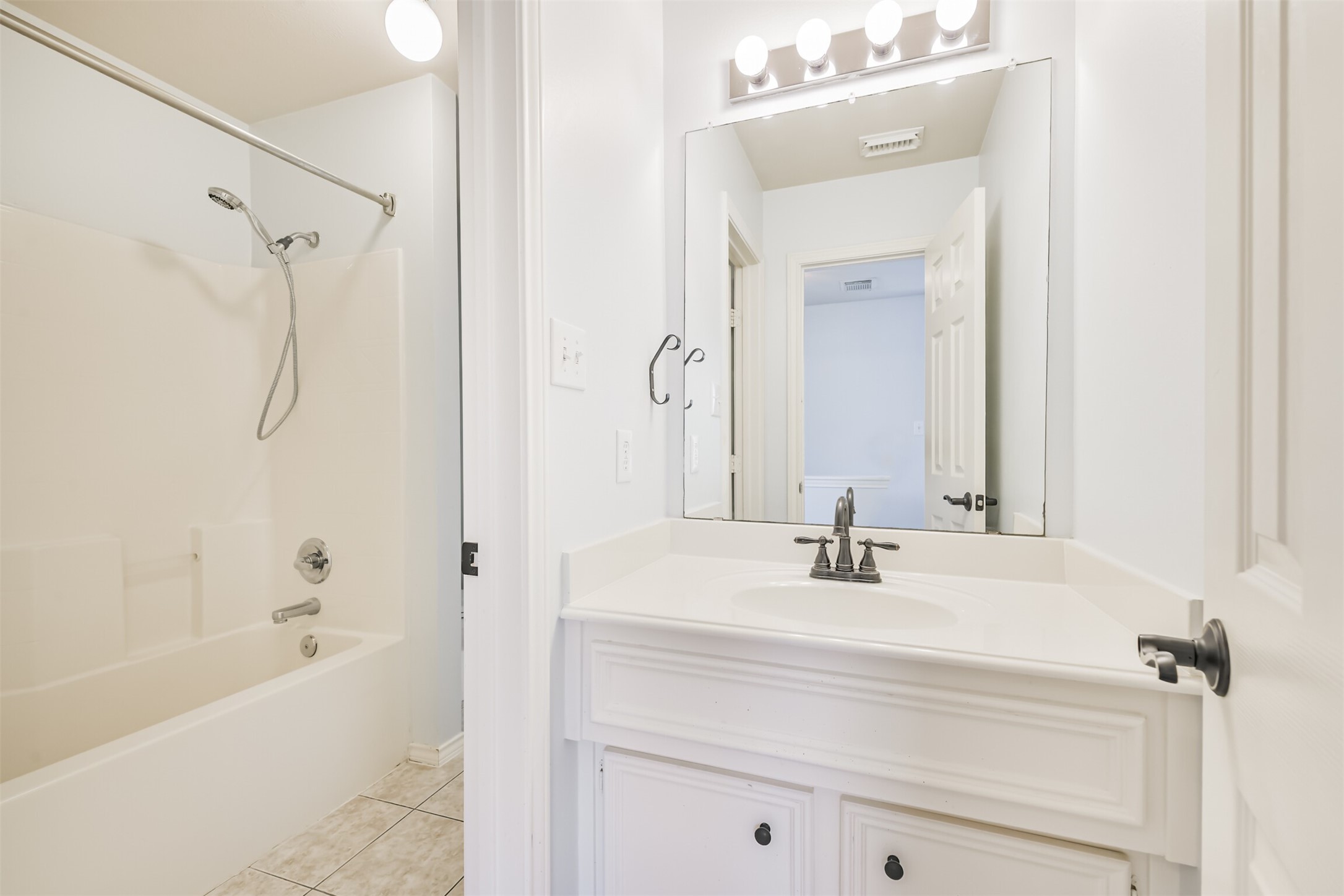 738 Redwing Pl Drive Houston, TX 77009 - Photo 16 of 23 a bathroom with a bathtub shower sink vanity and mirror