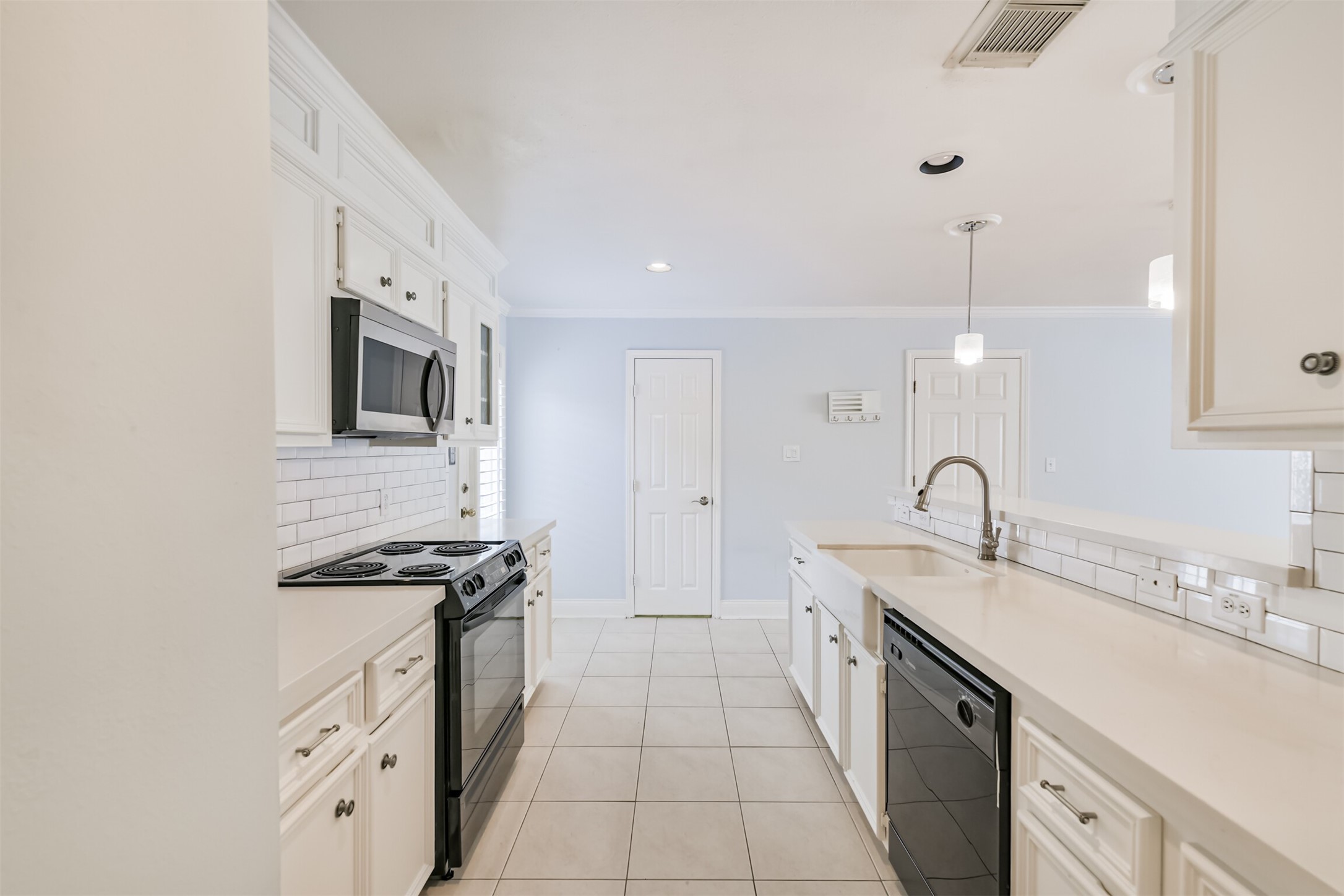 738 Redwing Pl Drive Houston, TX 77009 - Photo 19 of 23 a kitchen with stainless steel appliances a sink stove and cabinets