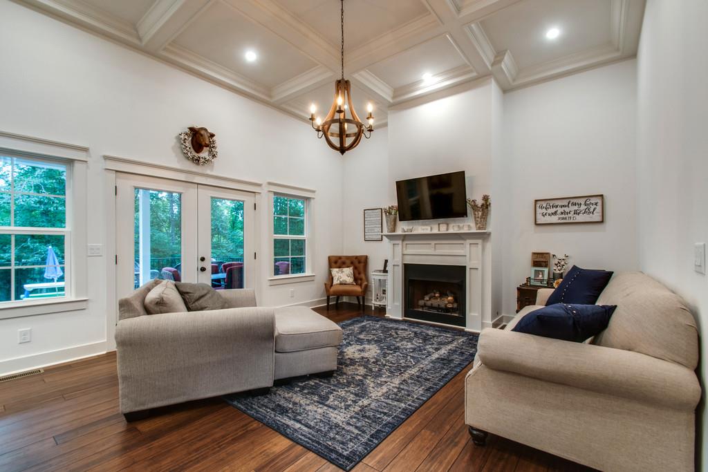 1335 Camp Ravine Road Burns, TN 37029 - Photo 11 of 29 a living room with furniture a fireplace and a flat screen tv