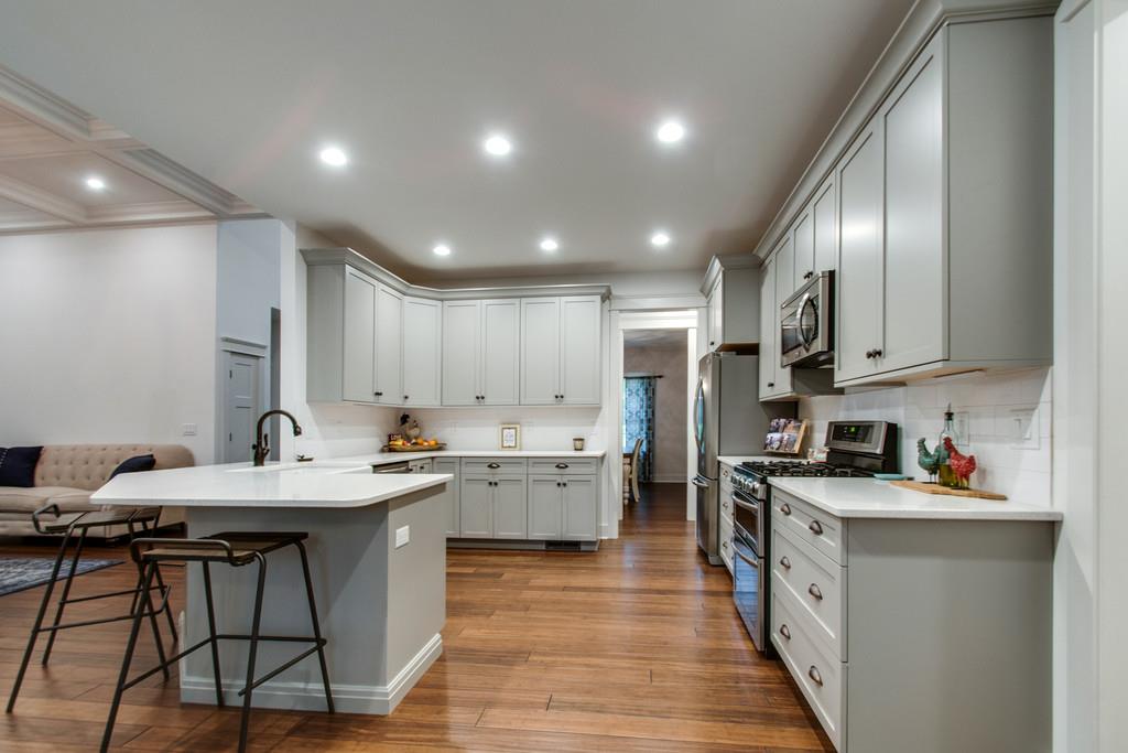 1335 Camp Ravine Road Burns, TN 37029 - Photo 15 of 29 a kitchen with stainless steel appliances kitchen island granite countertop a stove sink and cabinets