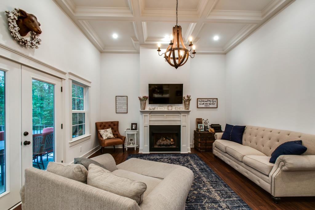 1335 Camp Ravine Road Burns, TN 37029 - Photo 9 of 29 a living room with furniture a flat screen tv and a fireplace