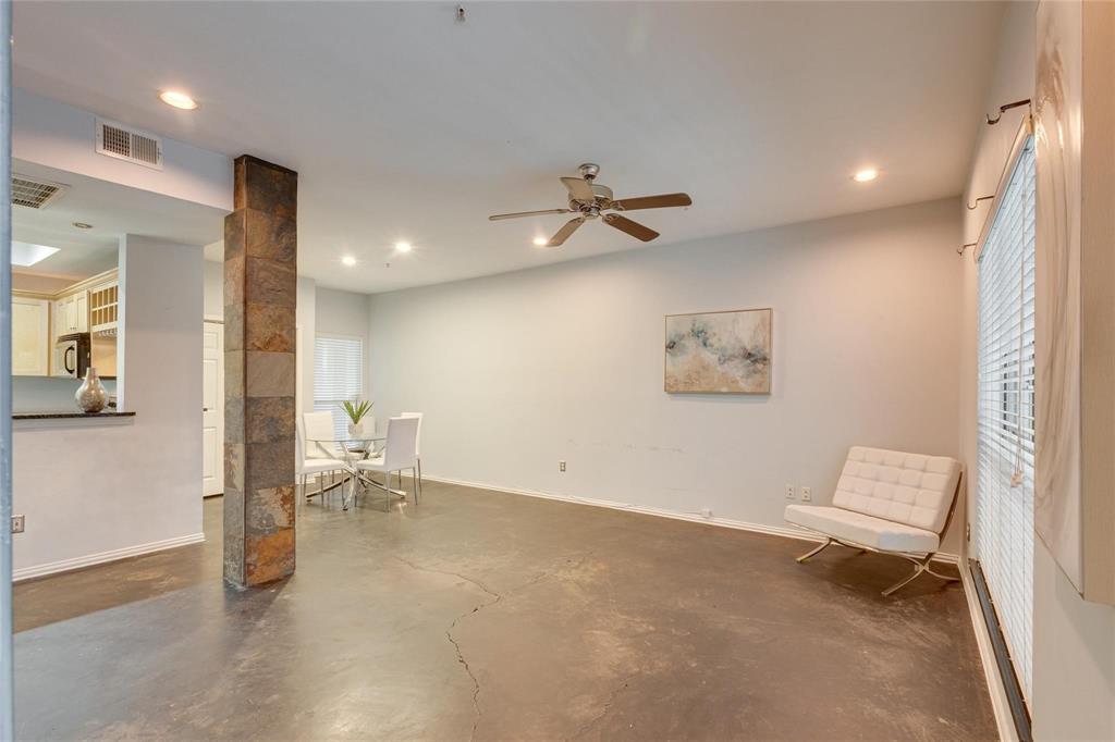4104 North Hall Street, Unit 102 Dallas, TX 75219 - Photo 7 of 18 Living area featuring concrete flooring and a stone-clad column