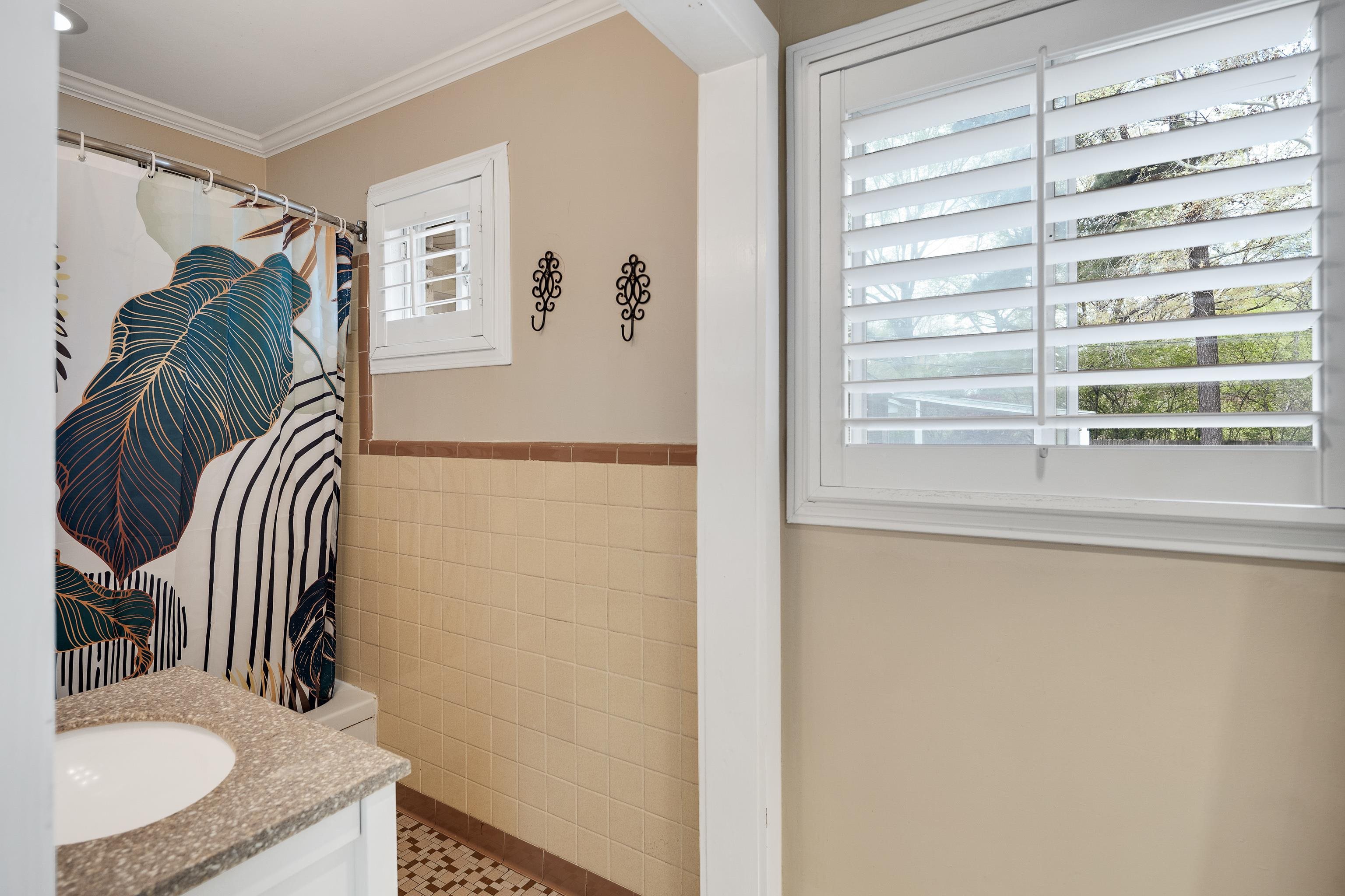 1130 Wilmore Road Memphis, TN 38117 - Photo 21 of 35 Bathroom featuring tile walls, curtained shower, vanity, a wainscoted wall, and crown molding