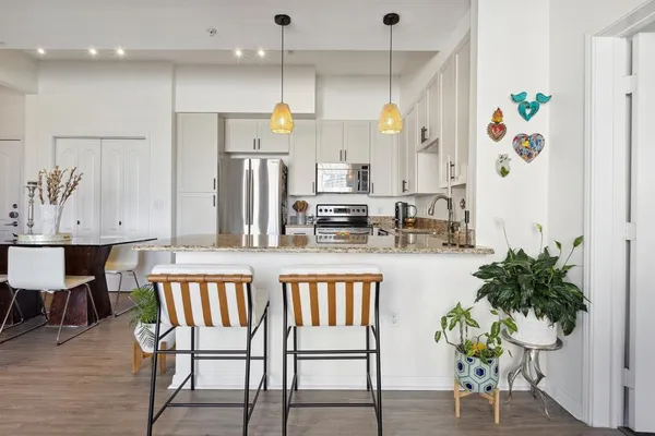 an open kitchen with dining table and chairs