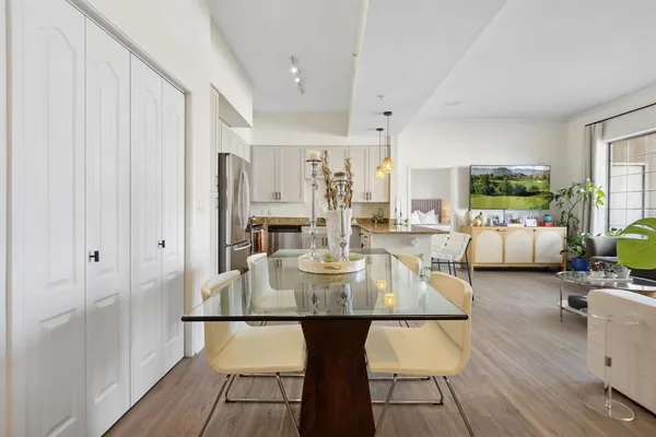 a view of a dining room with furniture window and wooden floor