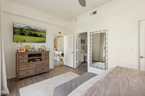 a bedroom with furniture and flat screen tv