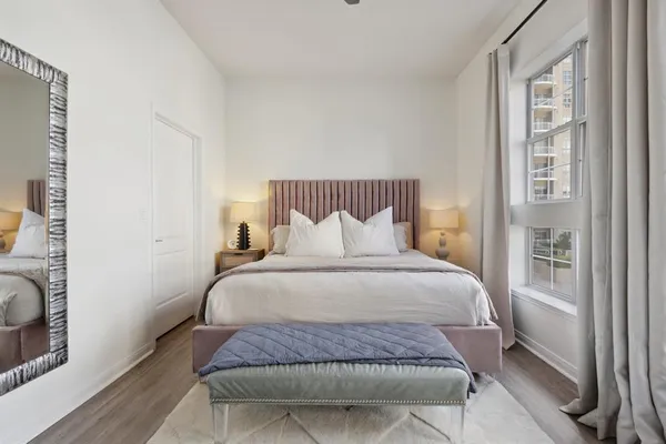 a bedroom with a bed and a window