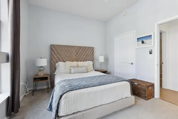 a bedroom with a bed and a chair