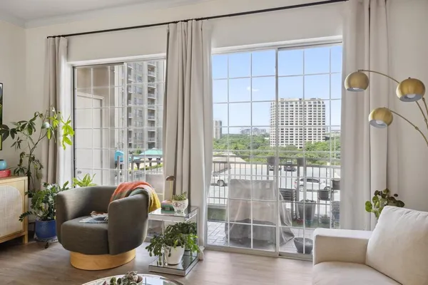 a living room with furniture and a floor to ceiling window