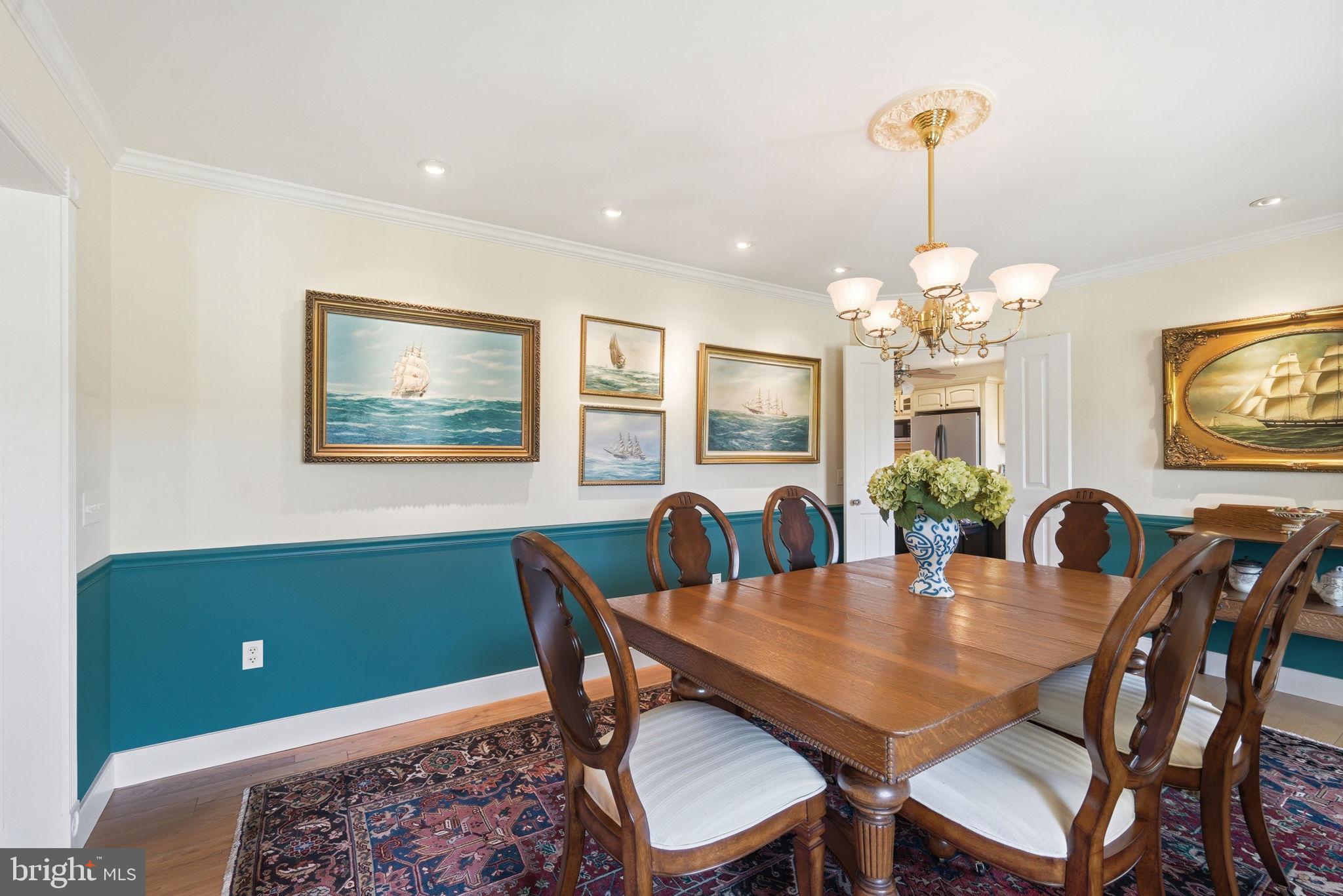 26226 Langs Landing Road Oxford, MD 21654 - Photo 19 of 48 a view of a dining room with furniture a chandelier and wooden floor