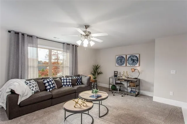 a living room with furniture and a large window