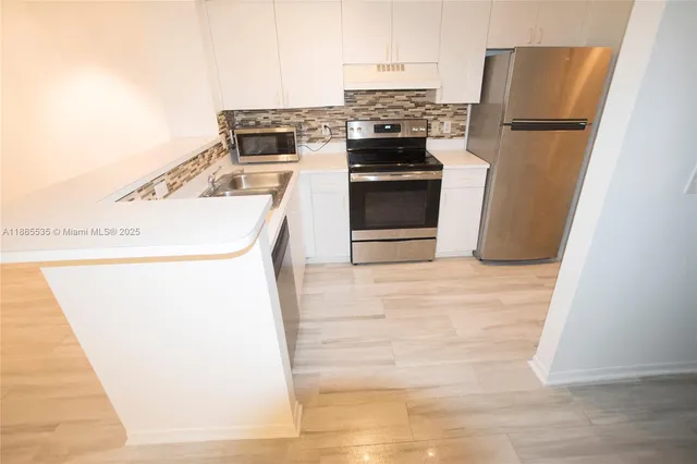 a kitchen with a refrigerator sink and stove