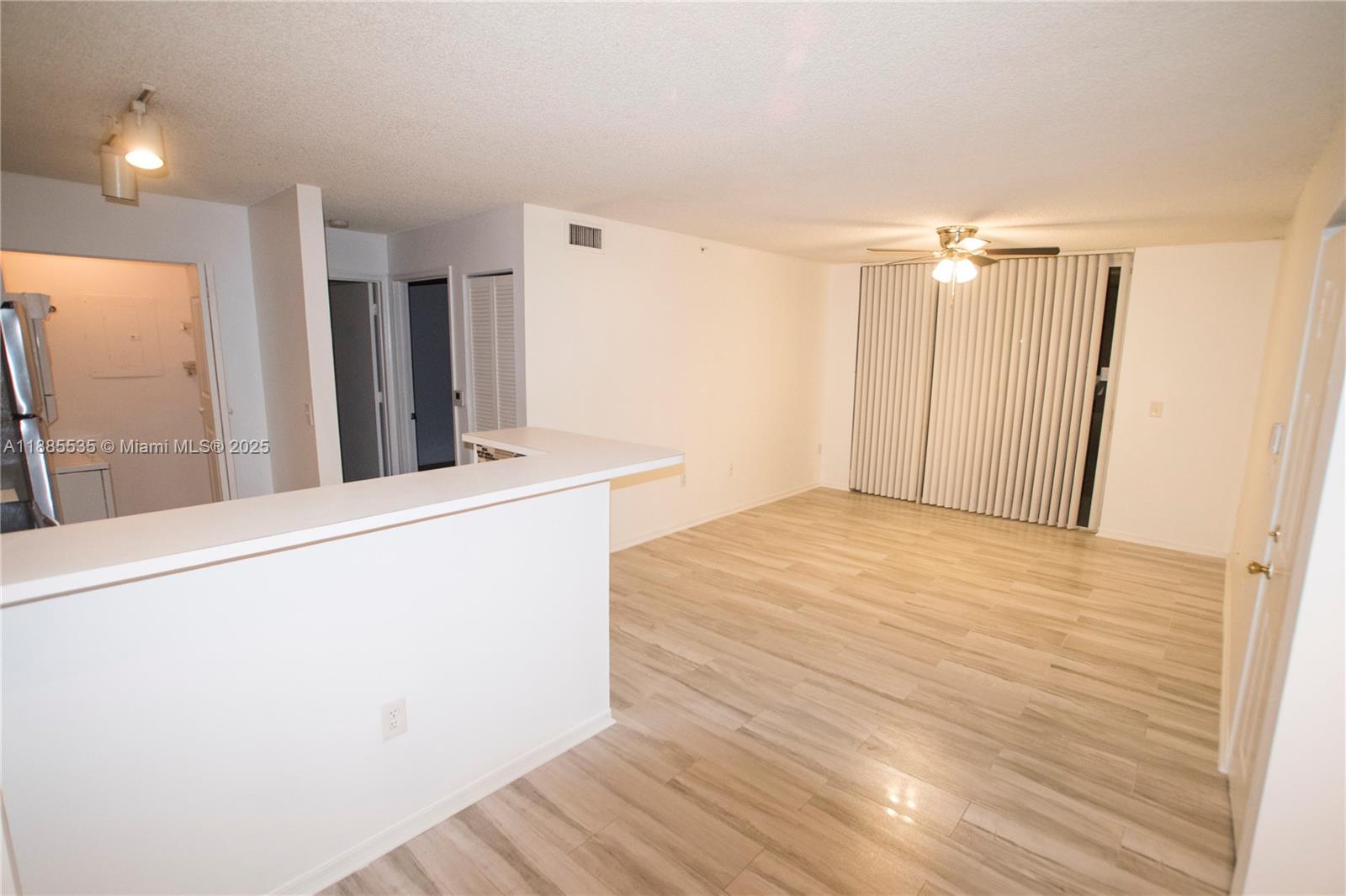 12130 St Andrews Place, Unit 101 Miramar, FL 33025 - Photo 5 of 13 a room with a refrigerator and a dresser