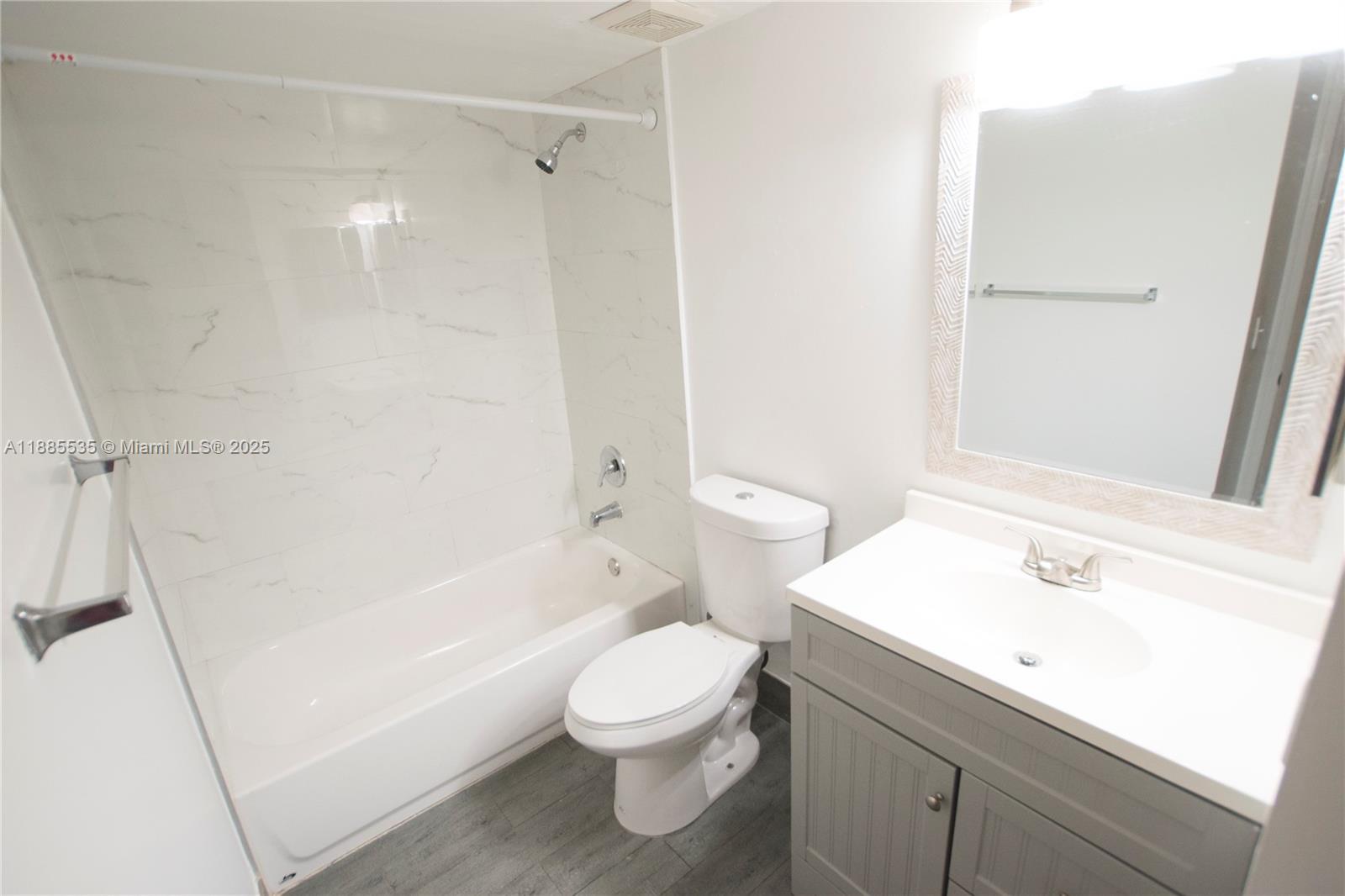 12130 St Andrews Place, Unit 101 Miramar, FL 33025 - Photo 7 of 13 a bathroom with a sink a toilet and shower