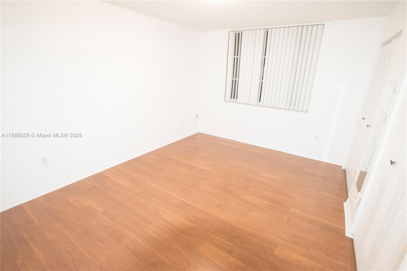 12130 St Andrews Place, Unit 101 Miramar, FL 33025 - Photo 8 of 13 an empty room with a window