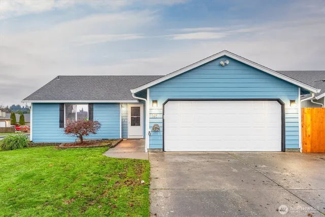 a backyard of a house with garden and garage