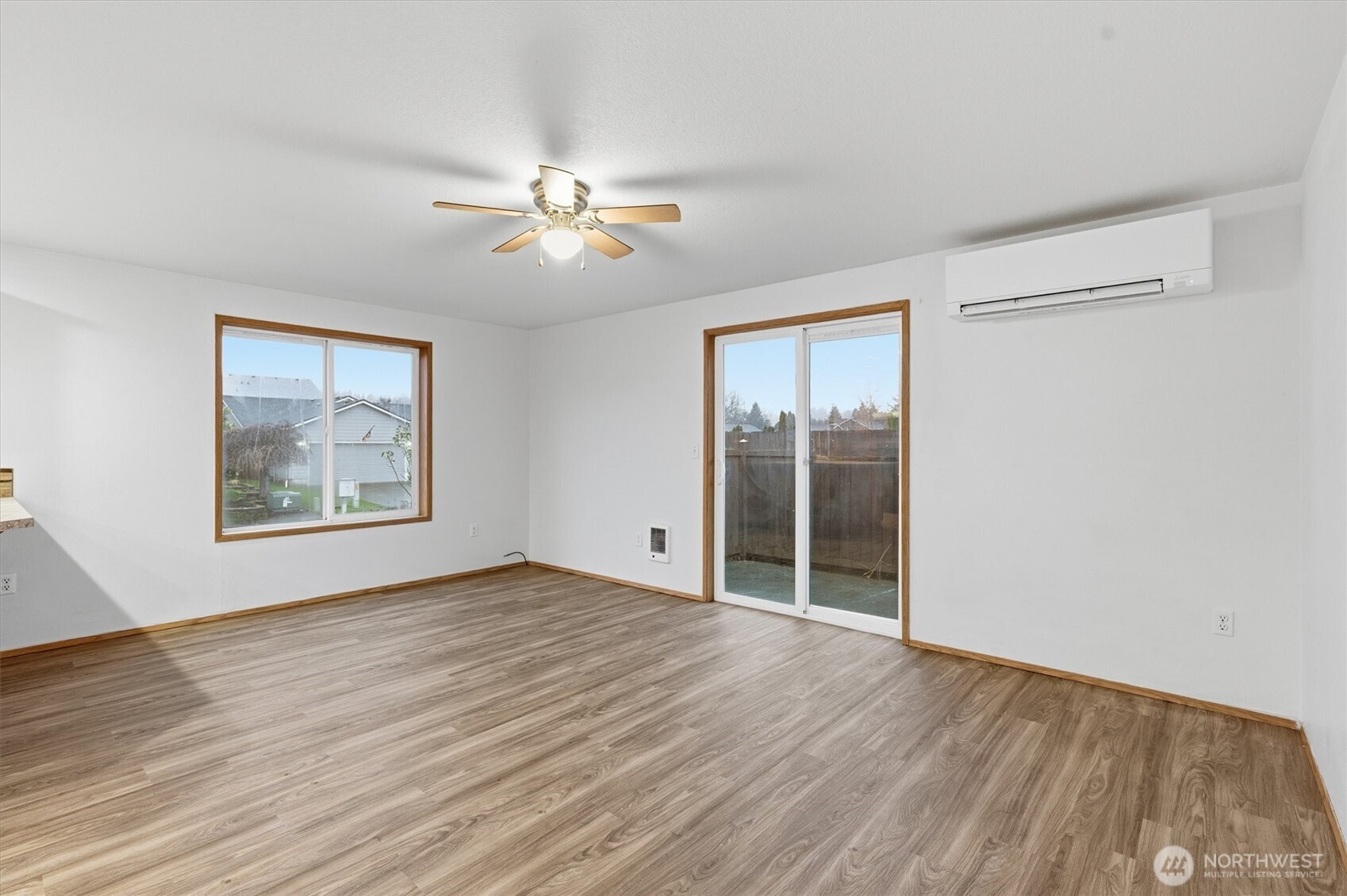 107 Mission Road Kelso, WA 98626 - Photo 12 of 32 a view of an empty room with a window and wooden floor