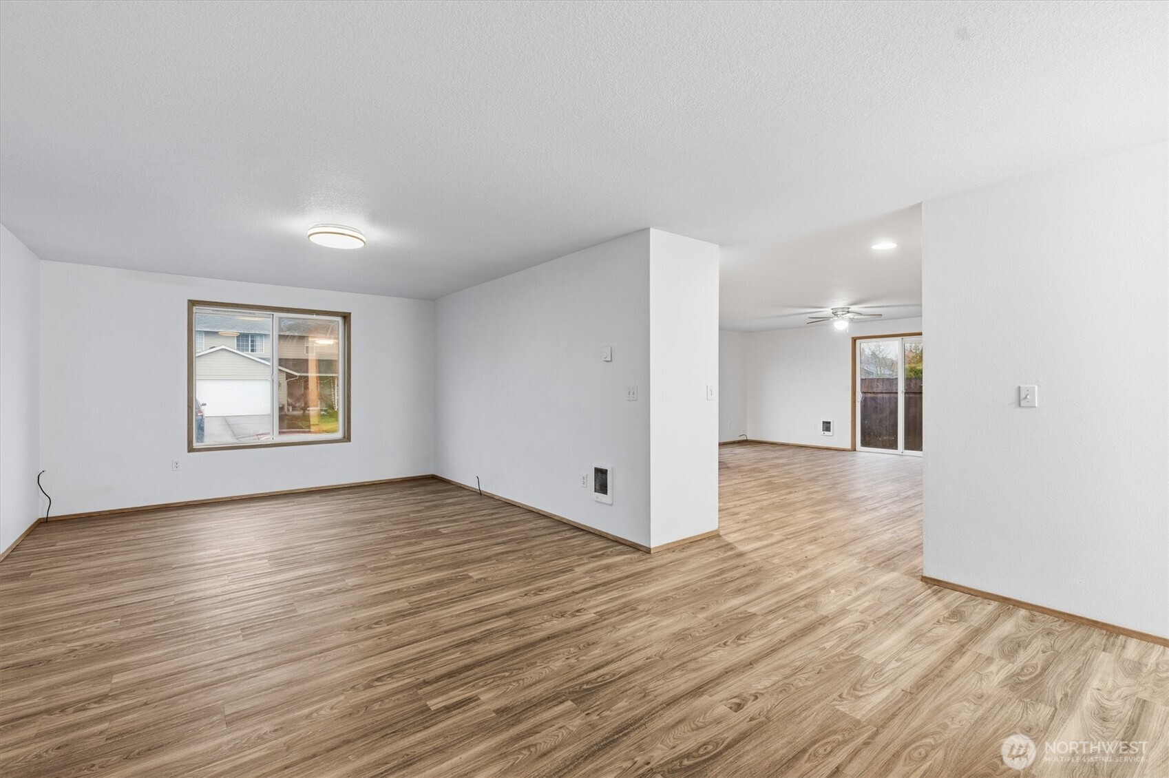 107 Mission Road Kelso, WA 98626 - Photo 3 of 32 a view of an empty room with wooden floor and a window