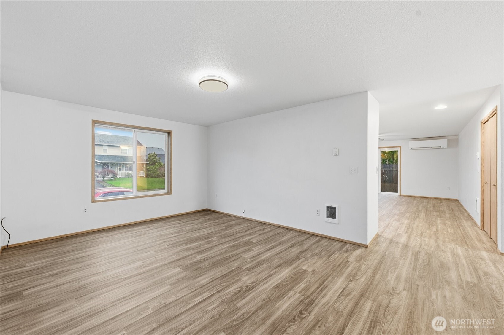 107 Mission Road Kelso, WA 98626 - Photo 6 of 32 an empty room with wooden floor and windows