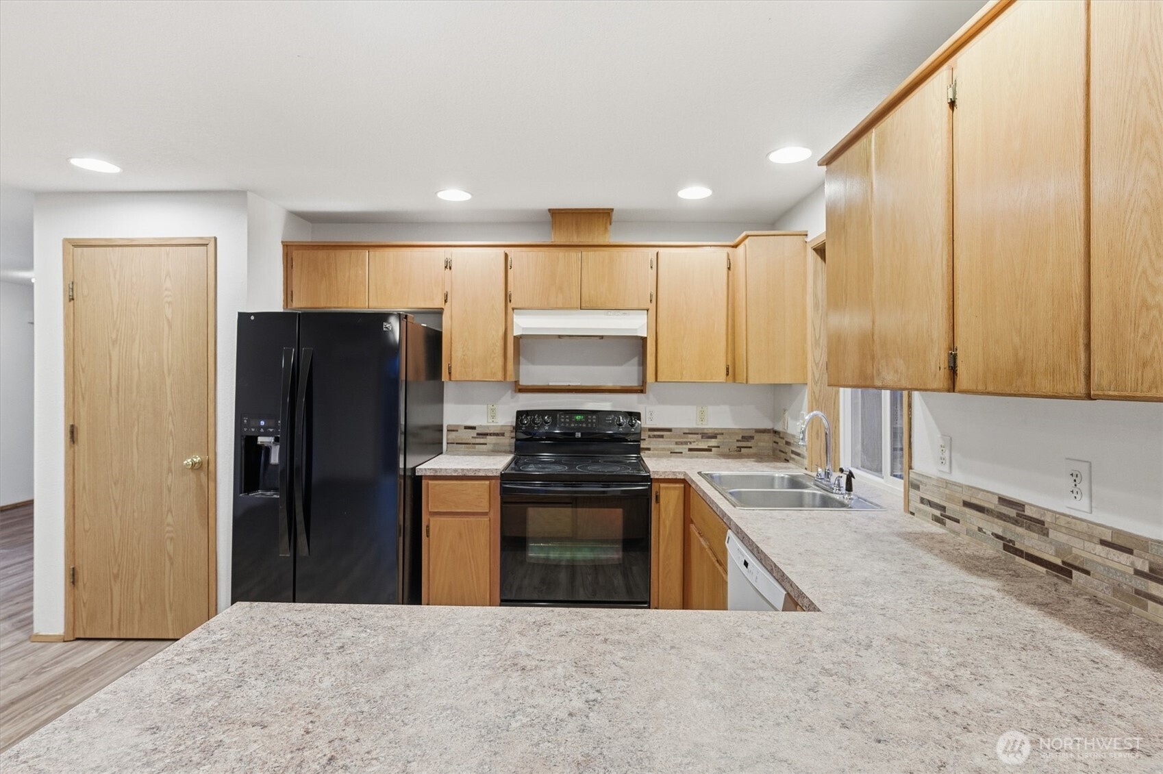 107 Mission Road Kelso, WA 98626 - Photo 10 of 32 a kitchen with stainless steel appliances granite countertop a stove a refrigerator and a sink