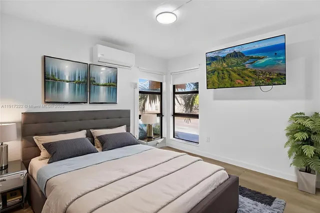 a bedroom with a bed and a painting on the wall