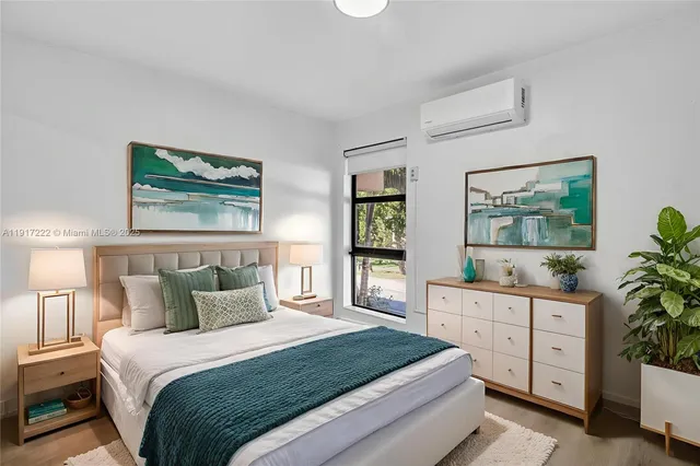 a bedroom with a bed and a large window