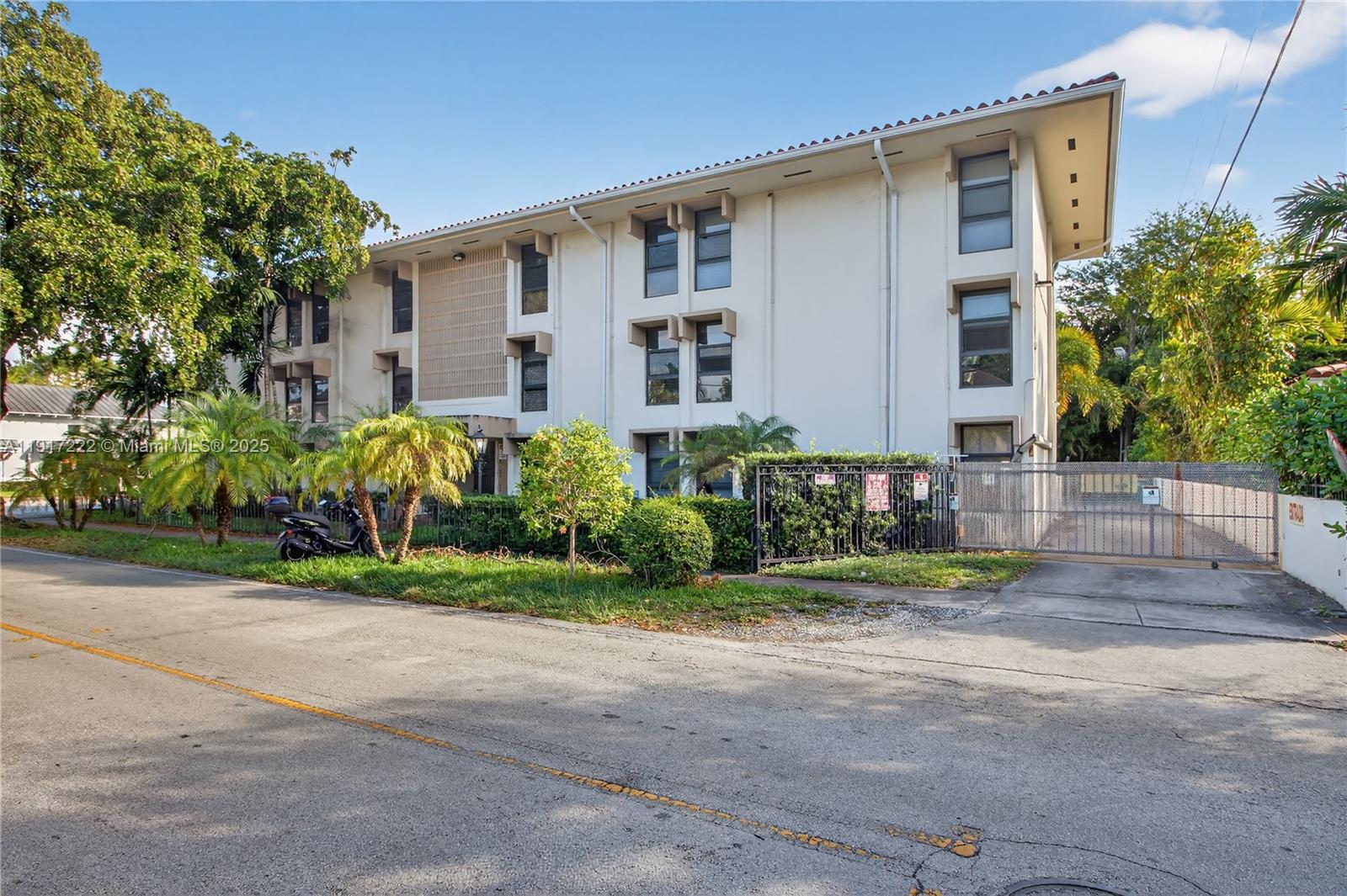 1600 South Le Jeune Road, Unit 7 Coral Gables, FL 33134 - Photo 2 of 20 a front view of a house with a yard and potted plants