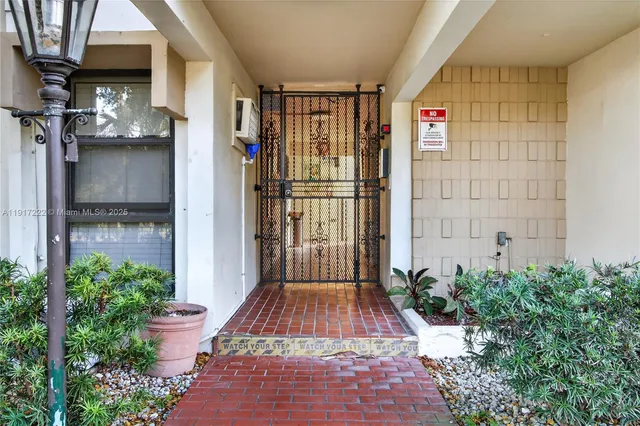 a view of entryway with a flower garden
