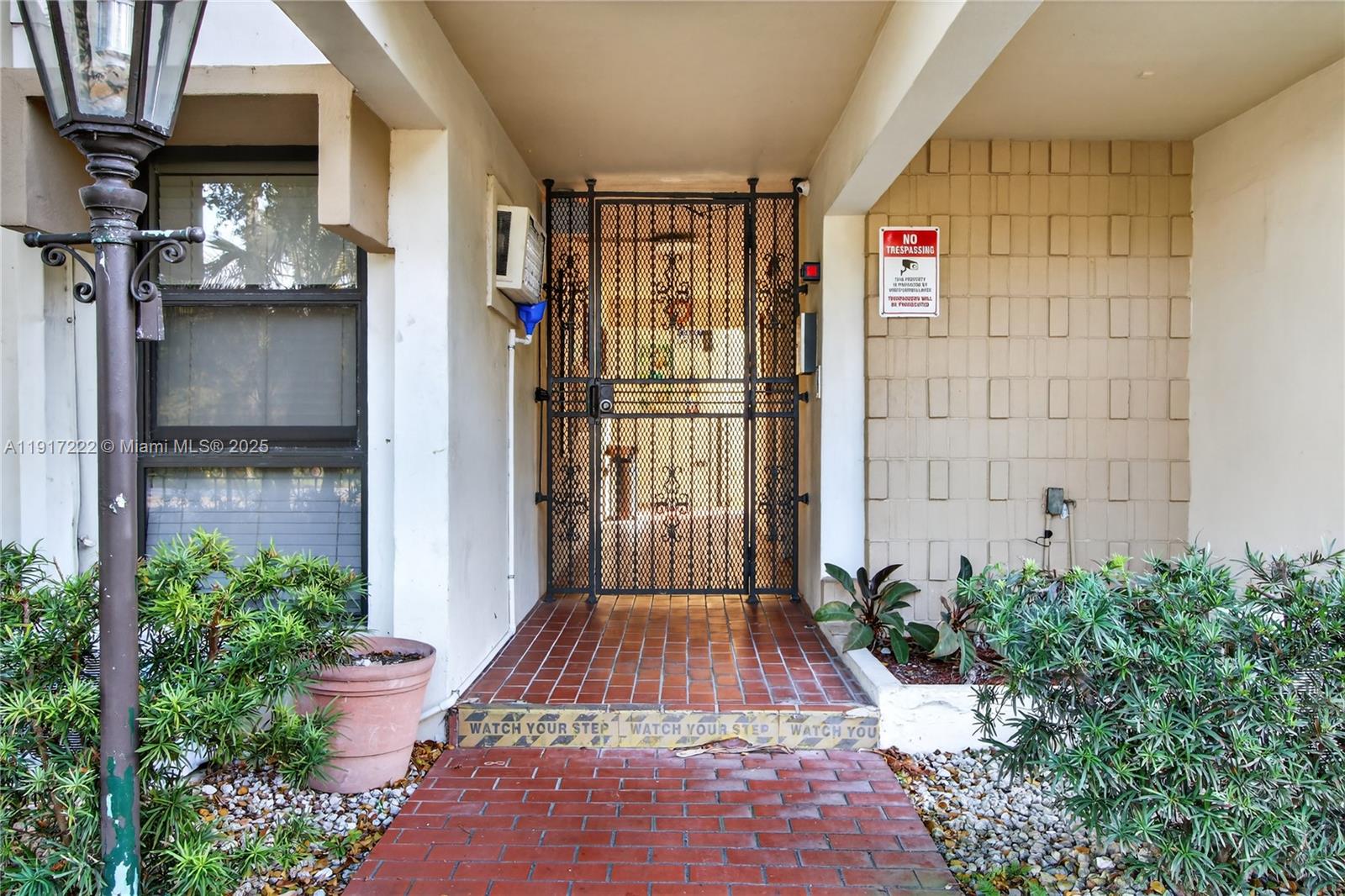 1600 South Le Jeune Road, Unit 7 Coral Gables, FL 33134 - Photo 3 of 20 a view of entryway with a flower garden
