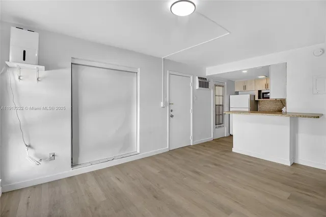 a view of a kitchen cabinets and wooden floor