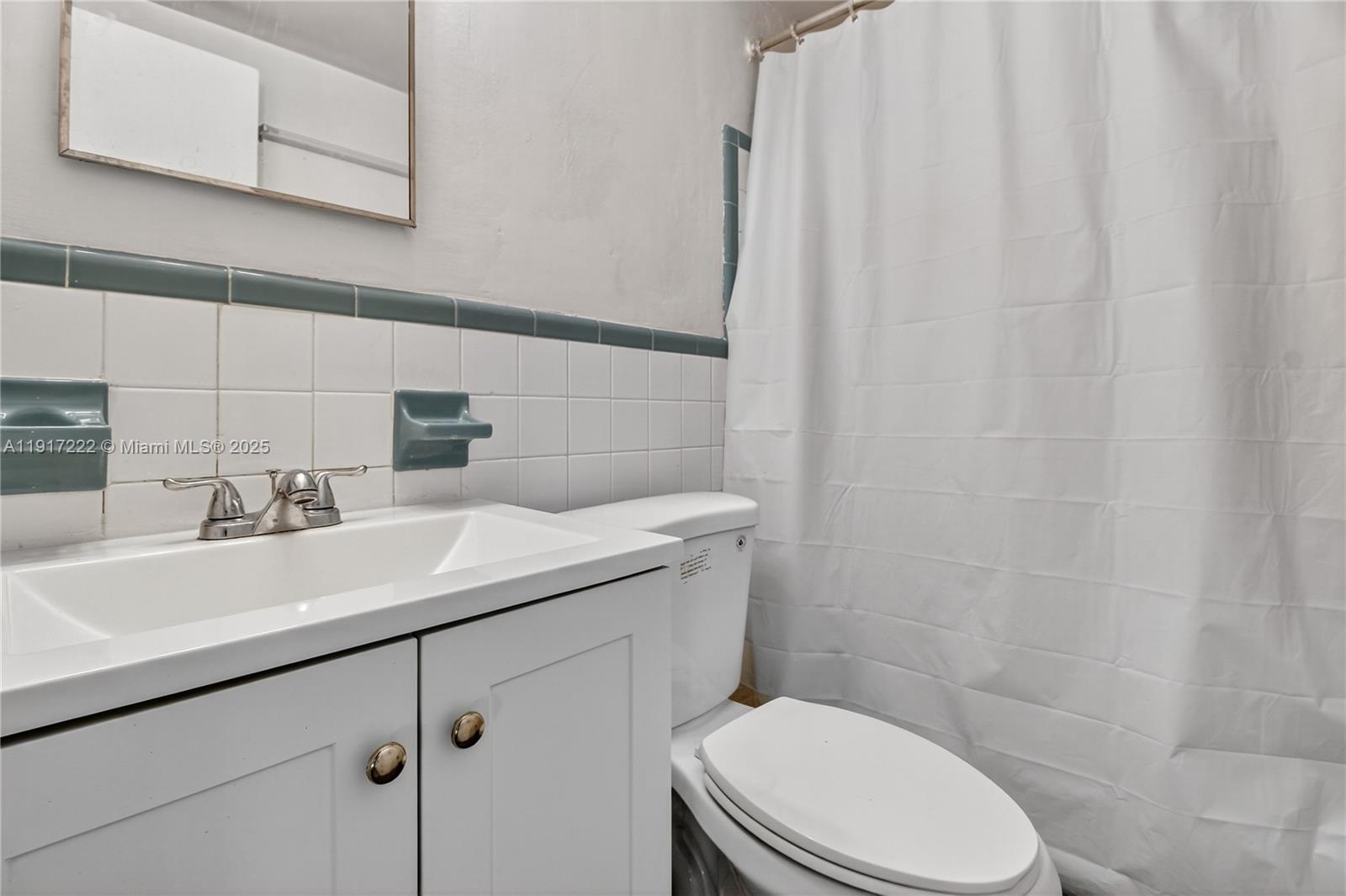 1600 South Le Jeune Road, Unit 7 Coral Gables, FL 33134 - Photo 9 of 20 a bathroom with a sink a toilet and shower