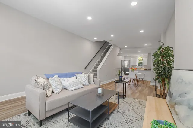 a living room with furniture and a potted plant