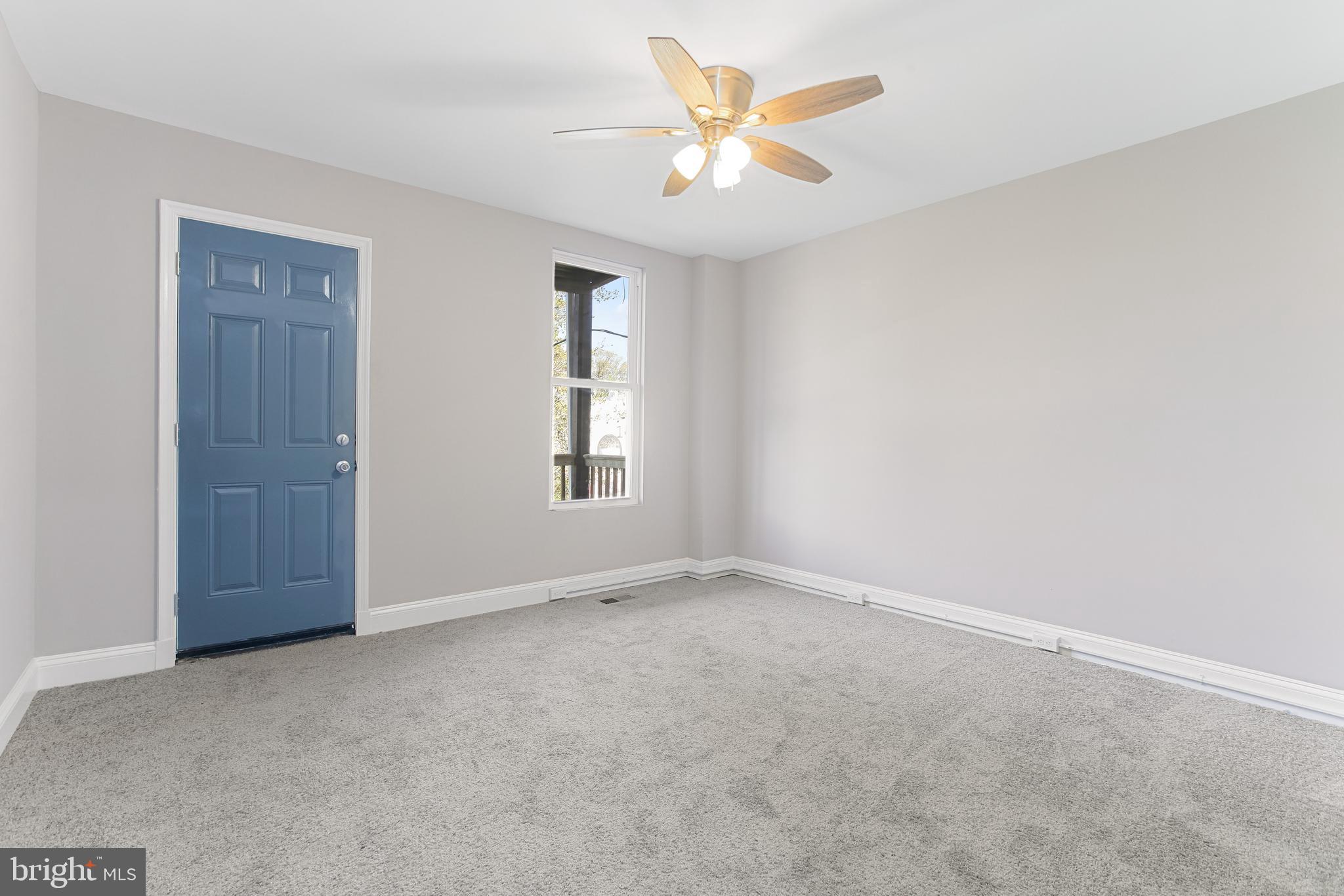 2712 Mosher Street Baltimore, MD 21216 - Photo 19 of 37 an empty room with windows and fan