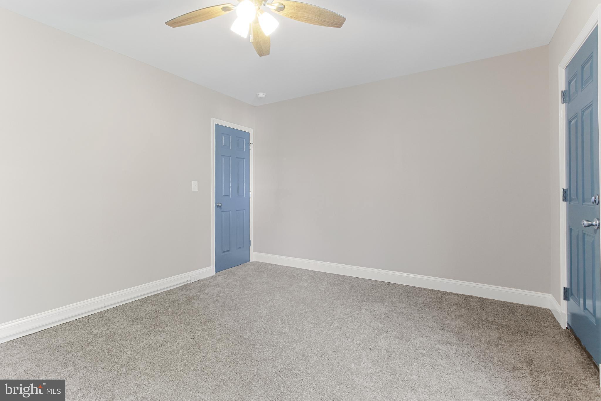 2712 Mosher Street Baltimore, MD 21216 - Photo 20 of 37 an empty room with a chandelier fan