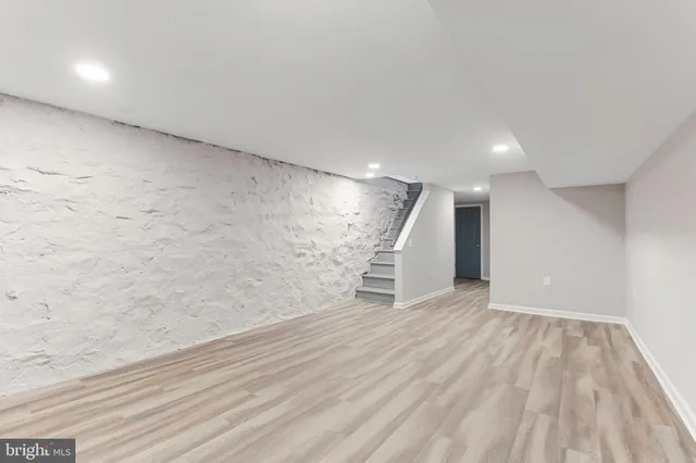 a view of empty room with stairs and ventilation