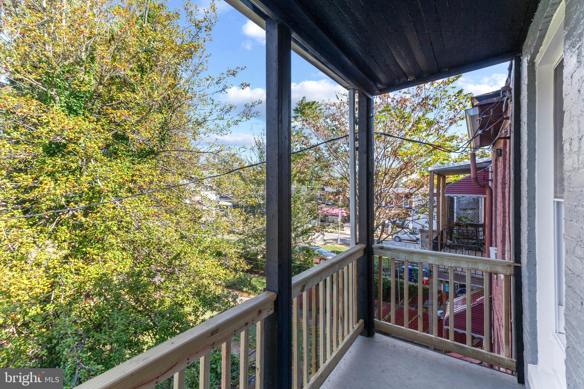 2712 Mosher Street Baltimore, MD 21216 - Photo 32 of 37 a view of a porch with a floor to ceiling window and wooden floor