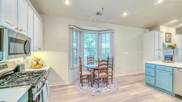 a kitchen with stainless steel appliances kitchen island granite countertop a sink and cabinets