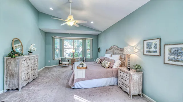 a bedroom with a bed and ceiling fan