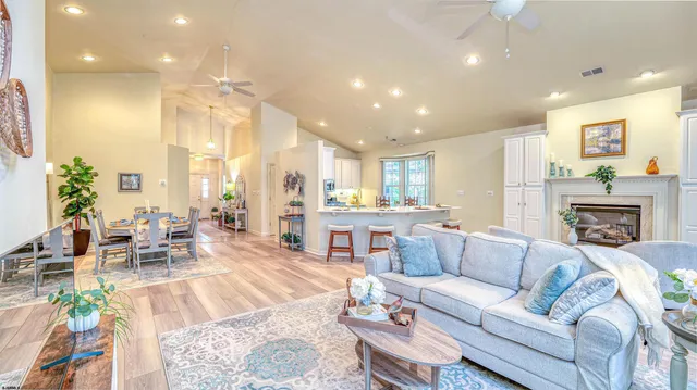 a living room with fireplace furniture and a large window