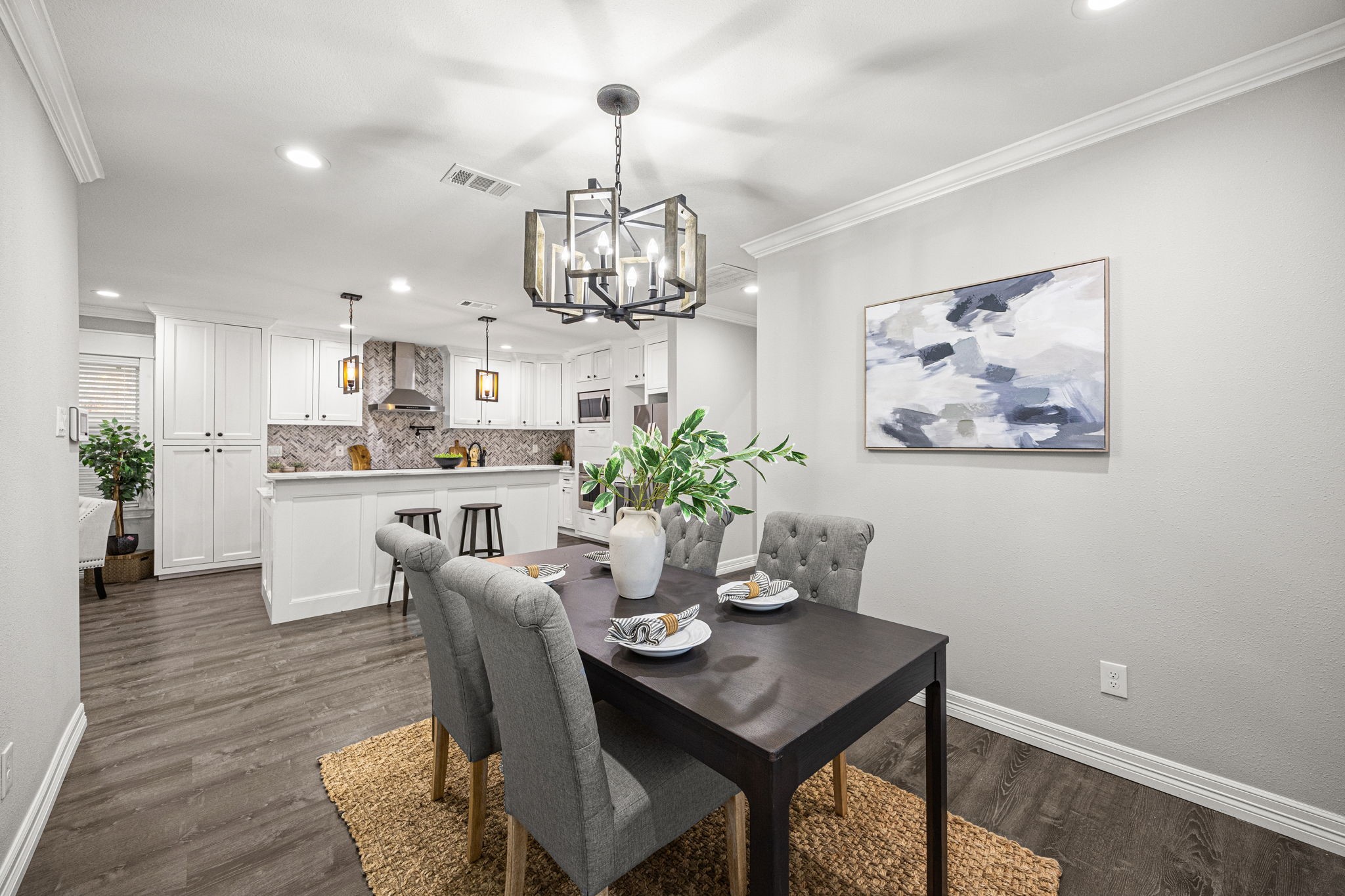 1405 Walton Street Houston, TX 77009 - Photo 12 of 28 Inviting dining space with designer chandelier, crown molding, and seamless flow into the beautifully updated kitchen.