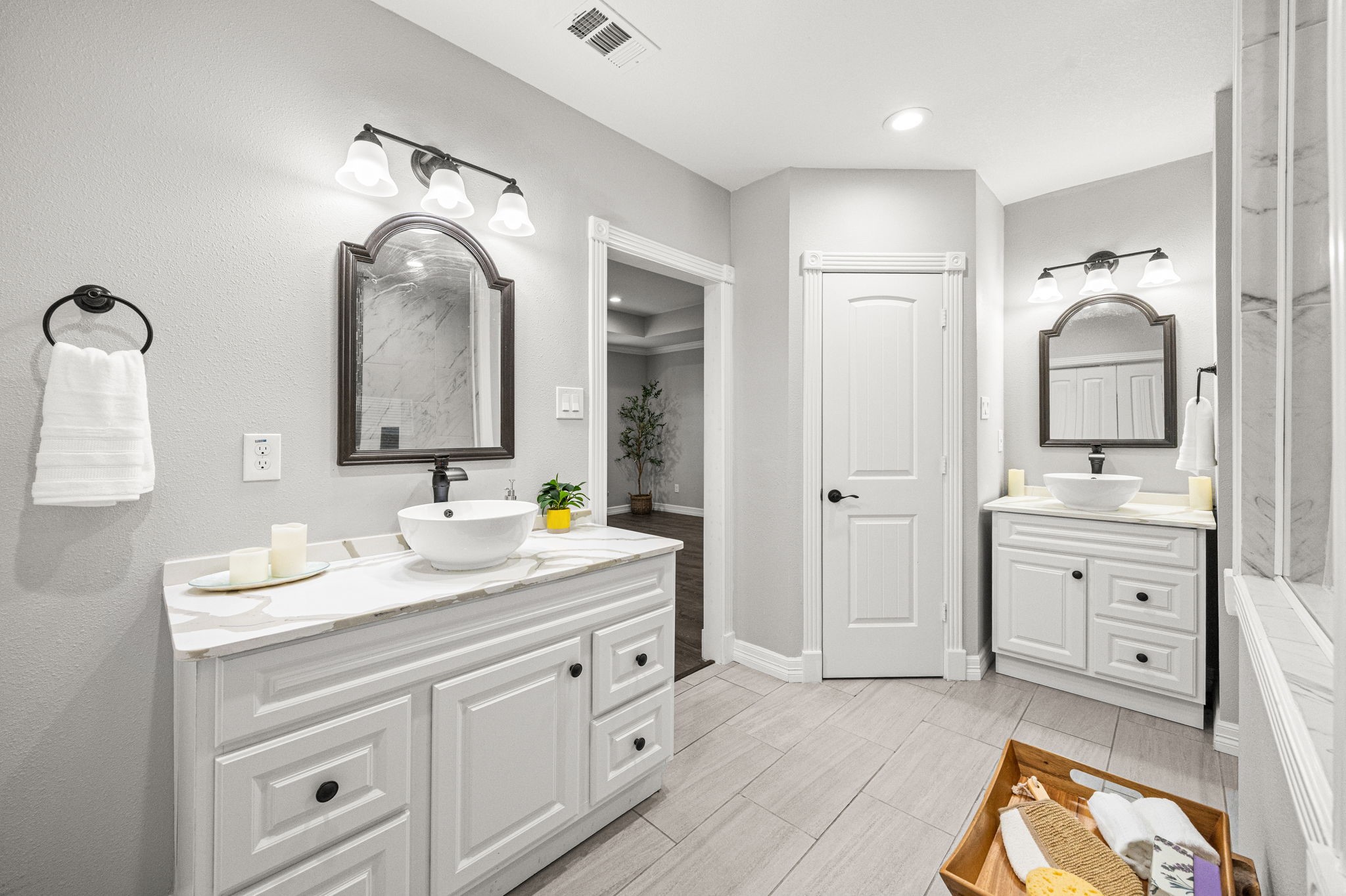1405 Walton Street Houston, TX 77009 - Photo 16 of 28 Expansive primary bathroom with dual quartz vanities, vessel sinks, custom cabinetry, and modern lighting for a clean, elevated look.