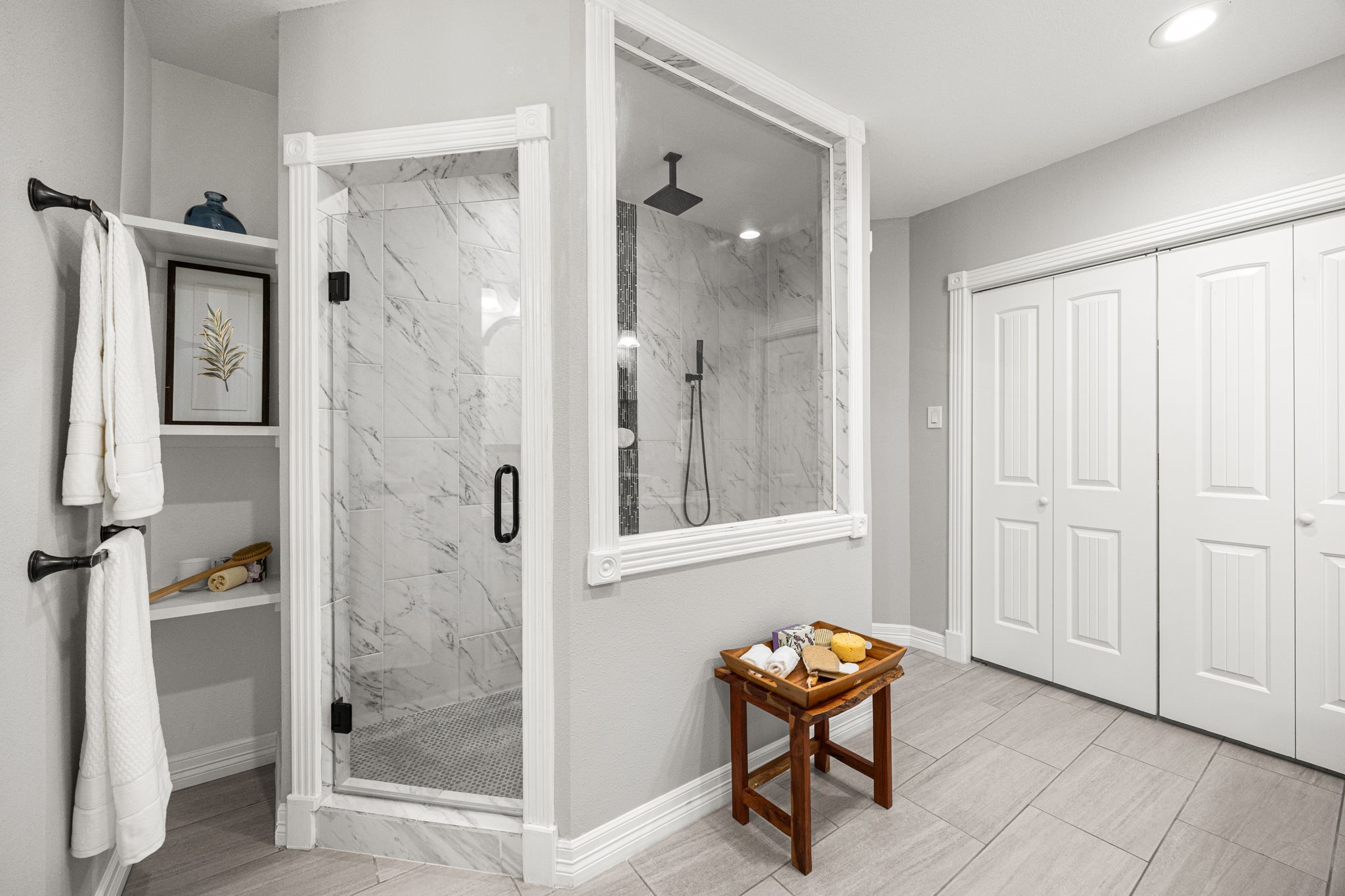 1405 Walton Street Houston, TX 77009 - Photo 17 of 28 Spa-inspired primary bath featuring oversized glass-enclosed shower, built-in shelving, and elegant finishes throughout.