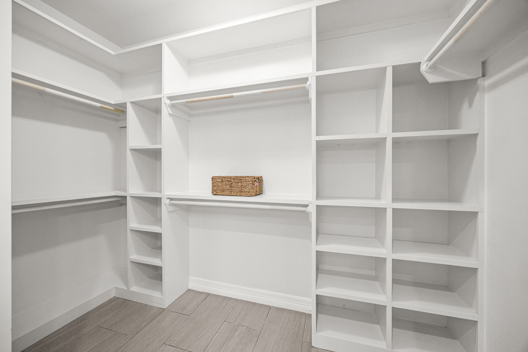 1405 Walton Street Houston, TX 77009 - Photo 19 of 28 Spacious walk-in closet with custom built-in shelving, hanging space, and organized storage for maximum functionality.