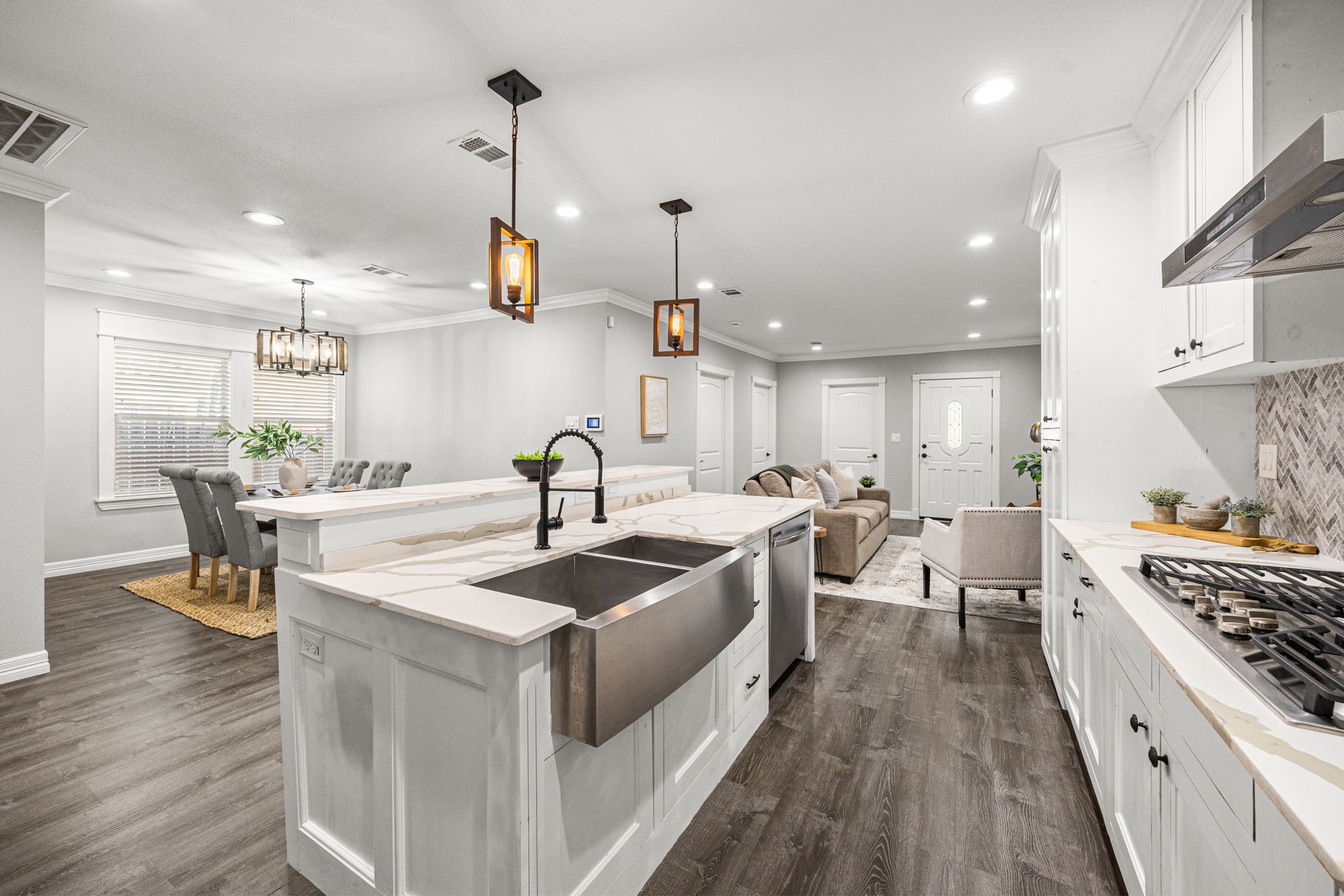 1405 Walton Street Houston, TX 77009 - Photo 8 of 28 Spacious center island with farmhouse sink, breakfast bar seating, and pendant lighting overlooking the main living and dining area.